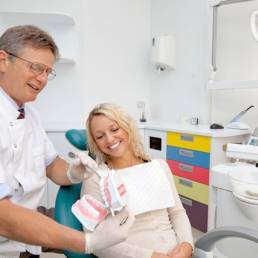 Dr Malcolm Deall with a patient at her hygiene and prevention dental appointment.